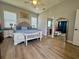 Serene main bedroom with stylish furnishings, ample natural light, and ensuite access at 4294 Cork Rd, Plant City, FL 33565