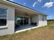 Covered patio with ceiling fan, sliding glass doors, and comfortable seating perfect for outdoor living at 4294 Cork Rd, Plant City, FL 33565