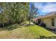 Spacious backyard featuring lush lawn and a screened lanai at 4425 Connery Ct, Palm Harbor, FL 34685