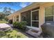 Backyard view featuring a screened lanai and mature trees at 4425 Connery Ct, Palm Harbor, FL 34685
