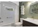 Well-lit bathroom featuring tiled shower and tub, sleek vanity, and decorative towel rack, offering a spa-like feel at 4425 Connery Ct, Palm Harbor, FL 34685