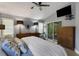 Bright bedroom featuring a ceiling fan, modern lighting, large windows, and sliding glass door for seamless indoor-outdoor living at 4425 Connery Ct, Palm Harbor, FL 34685