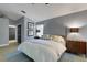 Bright bedroom offers a cozy bed, ceiling fan, modern lighting, and large windows, creating a serene and stylish space at 4425 Connery Ct, Palm Harbor, FL 34685