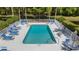 Aerial view of the community pool with tables, chairs, and a clear blue pool at 4425 Connery Ct, Palm Harbor, FL 34685