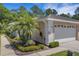 Well-maintained home exterior with a two-car garage, landscaping, and sidewalk at 4425 Connery Ct, Palm Harbor, FL 34685