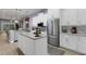 Open kitchen design concept with kitchen island, stainless steel appliances and modern white cabinets at 4425 Connery Ct, Palm Harbor, FL 34685