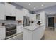 Modern kitchen featuring stainless steel appliances, white cabinetry, and an island with granite countertop at 4425 Connery Ct, Palm Harbor, FL 34685