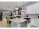 Open floor plan kitchen with modern lighting and a large kitchen island with an undermount sink at 4425 Connery Ct, Palm Harbor, FL 34685