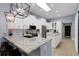 Bright, open kitchen with white cabinets, granite countertops, and stainless steel appliances at 4425 Connery Ct, Palm Harbor, FL 34685
