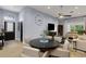 Open-concept living area with a TV, wood-look flooring, and comfortable seating arrangements at 4425 Connery Ct, Palm Harbor, FL 34685