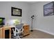 Light and bright office area with modern wood desk, art and overhead lighting at 4425 Connery Ct, Palm Harbor, FL 34685