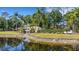 Scenic water view of the property, highlighting the backyard pond and surrounding trees at 4425 Connery Ct, Palm Harbor, FL 34685