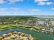 Stunning aerial view showcases waterfront homes, boat docks, and lush landscaping under a bright blue sky at 6202 Pasadena Point Blvd, Gulfport, FL 33707