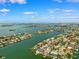 Expansive aerial view of an island community with luxurious homes, boat docks, and shimmering waterways at 6202 Pasadena Point Blvd, Gulfport, FL 33707