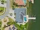 Aerial view of home with solar panels, pool, dock, and meticulous landscaping at 6202 Pasadena Point Blvd, Gulfport, FL 33707
