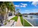 A meticulously landscaped backyard with artificial turf and waterfront views at 6202 Pasadena Point Blvd, Gulfport, FL 33707