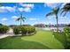 Enjoy the putting green and tropical landscaping in this backyard at 6202 Pasadena Point Blvd, Gulfport, FL 33707