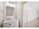 Bright bathroom featuring a marble vanity and modern lighting fixtures at 6202 Pasadena Point Blvd, Gulfport, FL 33707