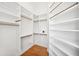Spacious walk-in closet features custom shelving and drawers for optimal storage and organization at 6202 Pasadena Point Blvd, Gulfport, FL 33707