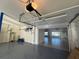 View from garage toward house revealing speckled epoxy flooring, storage, and water views at 6202 Pasadena Point Blvd, Gulfport, FL 33707