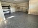Spacious garage featuring speckled epoxy floors and shelving for storage and organization at 6202 Pasadena Point Blvd, Gulfport, FL 33707