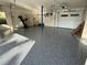 Spacious garage featuring speckled epoxy floors, a home gym and abundant room for storage at 6202 Pasadena Point Blvd, Gulfport, FL 33707