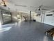 Large garage featuring speckled epoxy floors and plenty of space for parking and storage at 6202 Pasadena Point Blvd, Gulfport, FL 33707