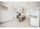 Bright, contemporary kitchen featuring custom cabinets, stainless steel appliances, and a center island with granite countertops at 6202 Pasadena Point Blvd, Gulfport, FL 33707