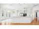 Bright kitchen features tile and wood flooring, stainless appliances, and white cabinetry at 6202 Pasadena Point Blvd, Gulfport, FL 33707