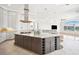 Spacious kitchen with granite island, stainless vent hood, and white and gray cabinetry at 6202 Pasadena Point Blvd, Gulfport, FL 33707