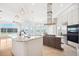 Bright kitchen with island, modern stainless steel appliances and light hardwood floors at 6202 Pasadena Point Blvd, Gulfport, FL 33707
