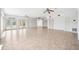Expansive living room with tile flooring, ceiling fans, and doors to the pool area at 6202 Pasadena Point Blvd, Gulfport, FL 33707