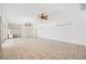 Spacious living room with tile flooring, ceiling fans, and a work station area at 6202 Pasadena Point Blvd, Gulfport, FL 33707