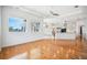 Open concept living room with hardwood floors and expansive windows offering water views at 6202 Pasadena Point Blvd, Gulfport, FL 33707