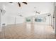 Large living room featuring tile flooring, ceiling fans, and water views from large windows at 6202 Pasadena Point Blvd, Gulfport, FL 33707