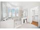 Spacious main bathroom featuring a glass-enclosed shower with arched windows and a heated towel rack at 6202 Pasadena Point Blvd, Gulfport, FL 33707