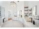 Elegant main bathroom with a crystal chandelier, dual vanities, and floating shelves at 6202 Pasadena Point Blvd, Gulfport, FL 33707