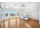 Spacious main bedroom featuring tray ceilings, hardwood floors, and water views from multiple large windows at 6202 Pasadena Point Blvd, Gulfport, FL 33707