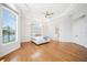 Bright main bedroom with tray ceilings, hardwood floors, and ample natural light from large windows at 6202 Pasadena Point Blvd, Gulfport, FL 33707