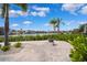 Paver patio with views of the water, tropical landscaping and fire pit at 6202 Pasadena Point Blvd, Gulfport, FL 33707