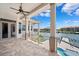 A covered outdoor patio with water views and ceiling fan at 6202 Pasadena Point Blvd, Gulfport, FL 33707