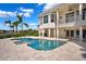 Inviting pool area with travertine patio and lush tropical landscaping at 6202 Pasadena Point Blvd, Gulfport, FL 33707