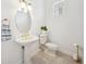 Powder room with pedestal sink, oval mirror, gold fixtures, and tile flooring at 6202 Pasadena Point Blvd, Gulfport, FL 33707