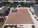 Aerial view of a single-story home featuring a screen enclosed pool and a private boat dock along a canal at 6528 Santiago Ct, Apollo Beach, FL 33572