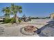Picturesque backyard with a fire pit, palm trees, lush landscaping, and views of the waterfront at 6528 Santiago Ct, Apollo Beach, FL 33572