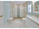 A bathroom featuring marble floors, a renovated shower with bench, and updated countertops at 6528 Santiago Ct, Apollo Beach, FL 33572