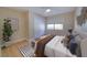 Bright bedroom with a ceiling fan, closet, and large window bringing in natural light at 6528 Santiago Ct, Apollo Beach, FL 33572