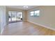 Open bedroom featuring wood-look flooring, natural light, and sliding glass doors to the lanai at 6528 Santiago Ct, Apollo Beach, FL 33572
