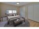 Cozy bedroom featuring a queen bed, ceiling fan, neutral décor, and closet doors at 6528 Santiago Ct, Apollo Beach, FL 33572