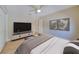 Bedroom featuring a tv, neutral walls, ceiling fan, and closet doors at 6528 Santiago Ct, Apollo Beach, FL 33572